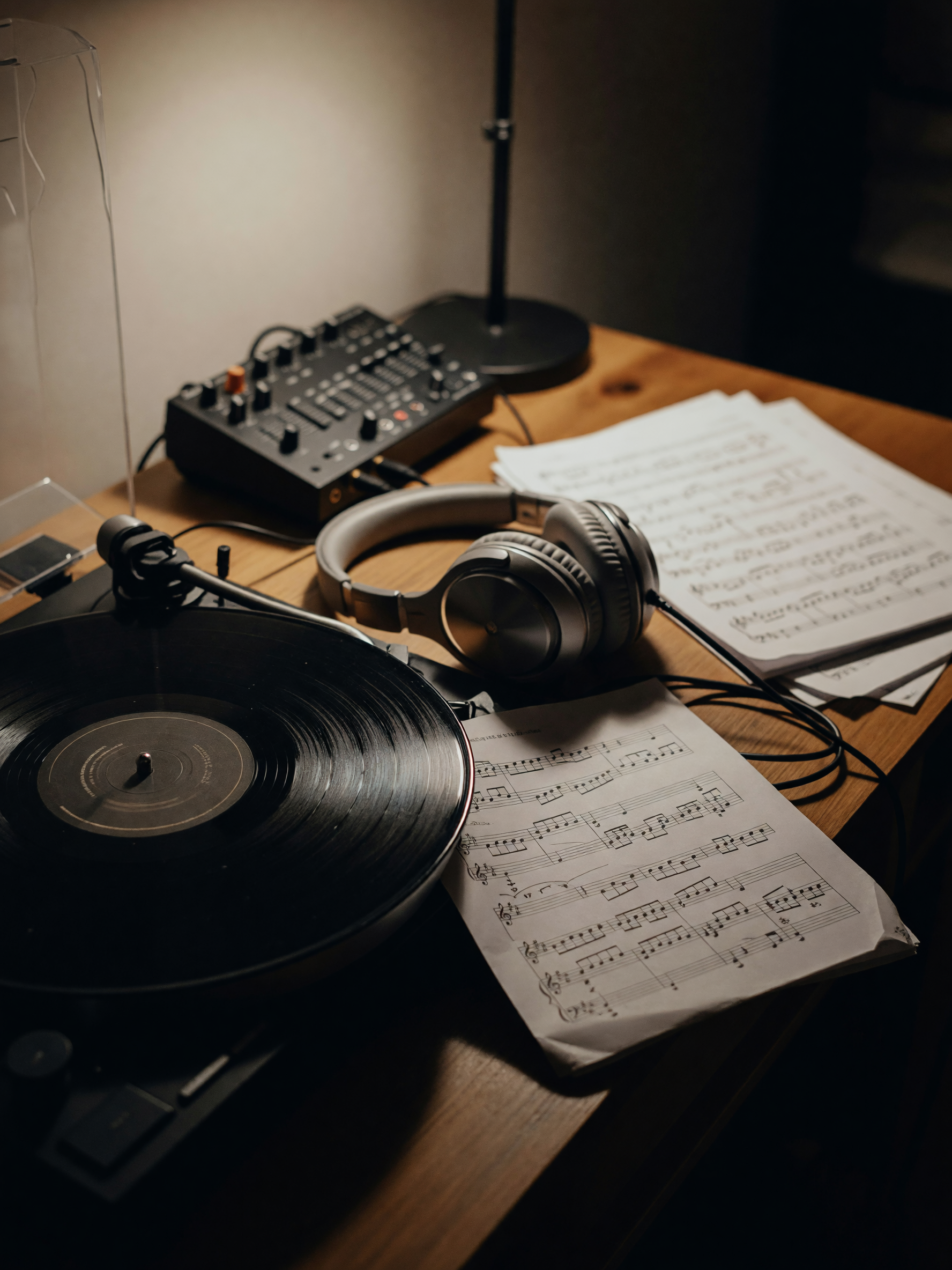new record spinning while i work on a beat, headphones on, old sheet music sprea