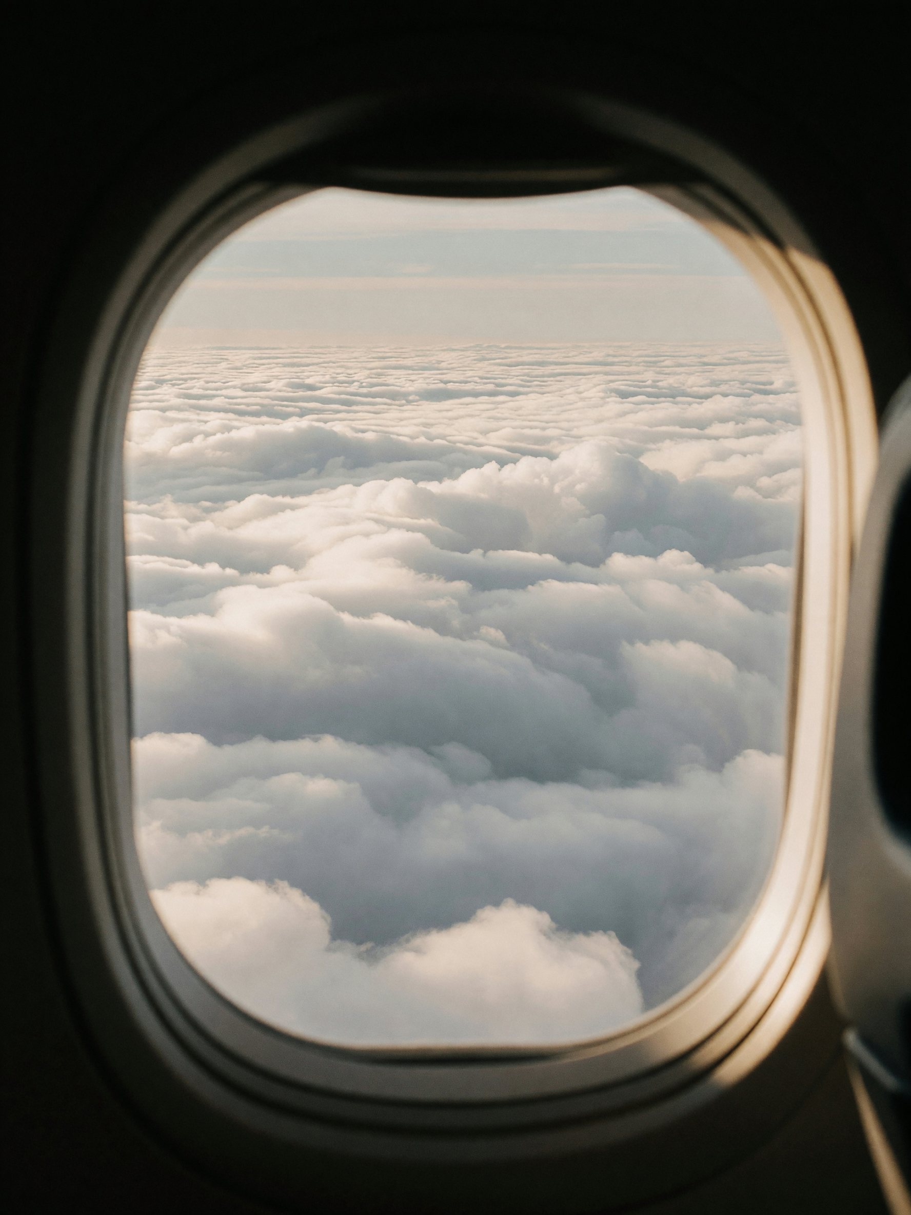 stuck at the gate watching clouds stack up outside the window. flight delayed bu