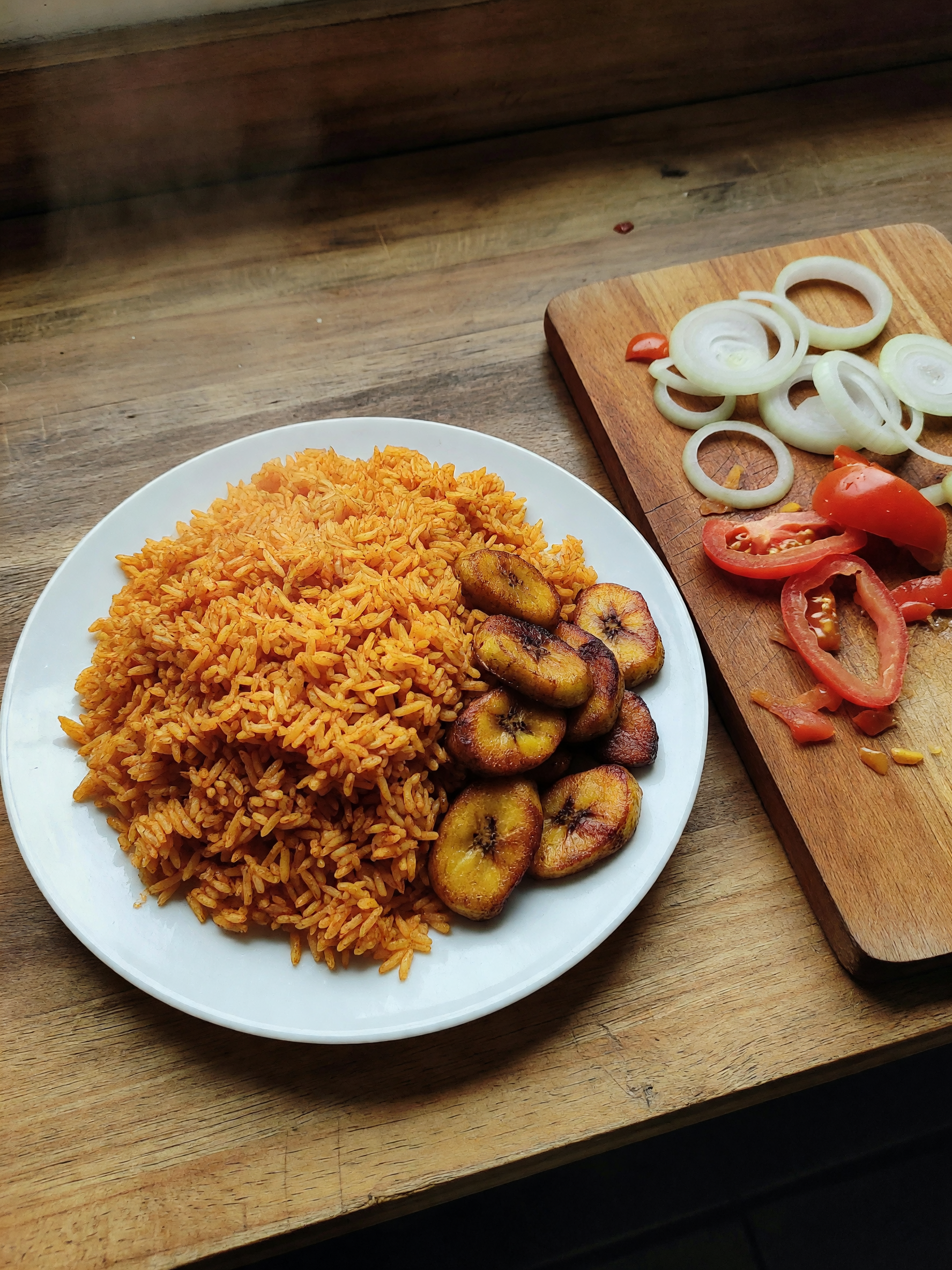 jollof rice simmering, plantains crisping, music loud in the background. smelled
