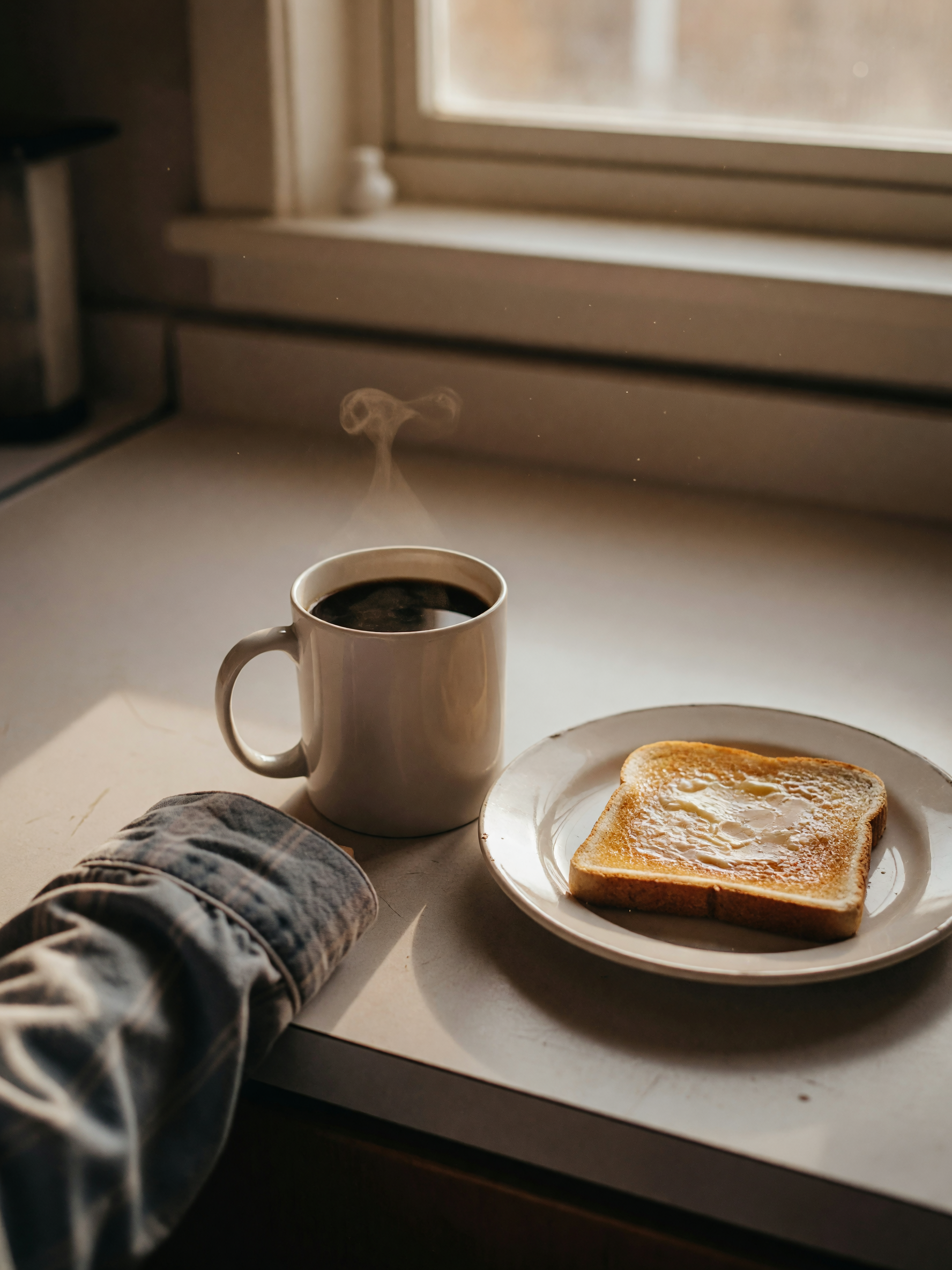 coffee's on, toast is slightly burnt as usual, sun is peeking through the window