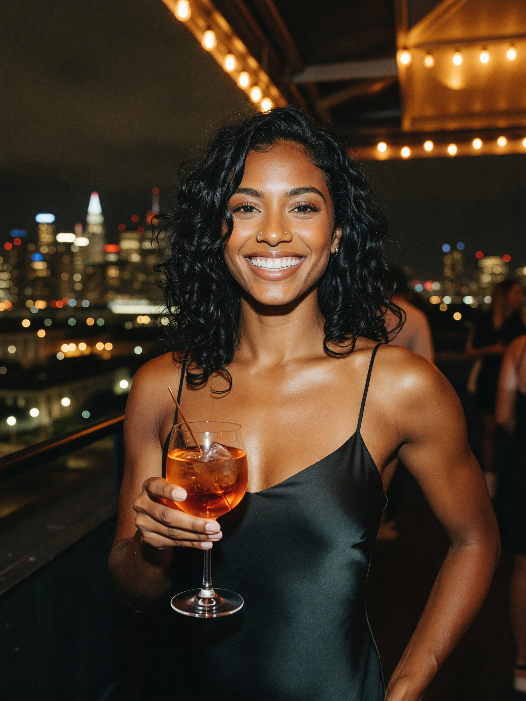 cocktail in hand, city lights doing their thing behind me. slip dress caught the