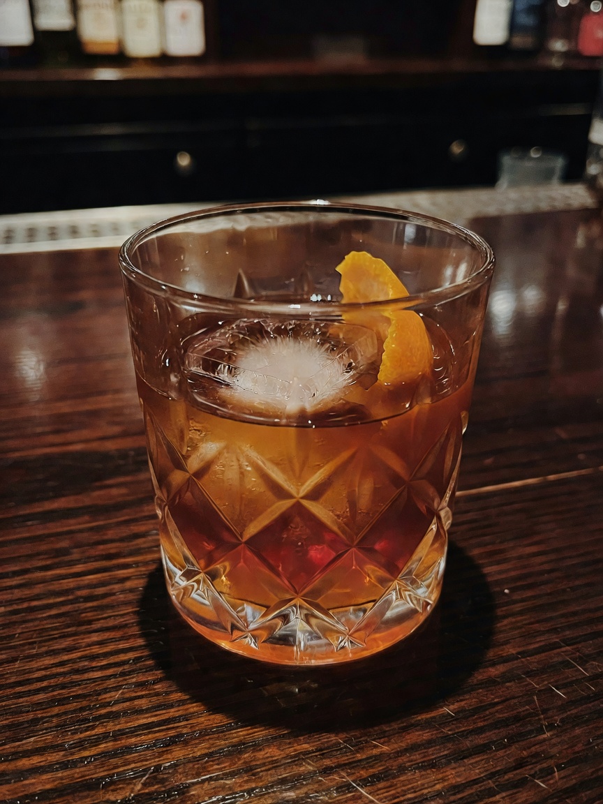 Bartender making my usual old fashioned perfectly. Love the neon glow in here af